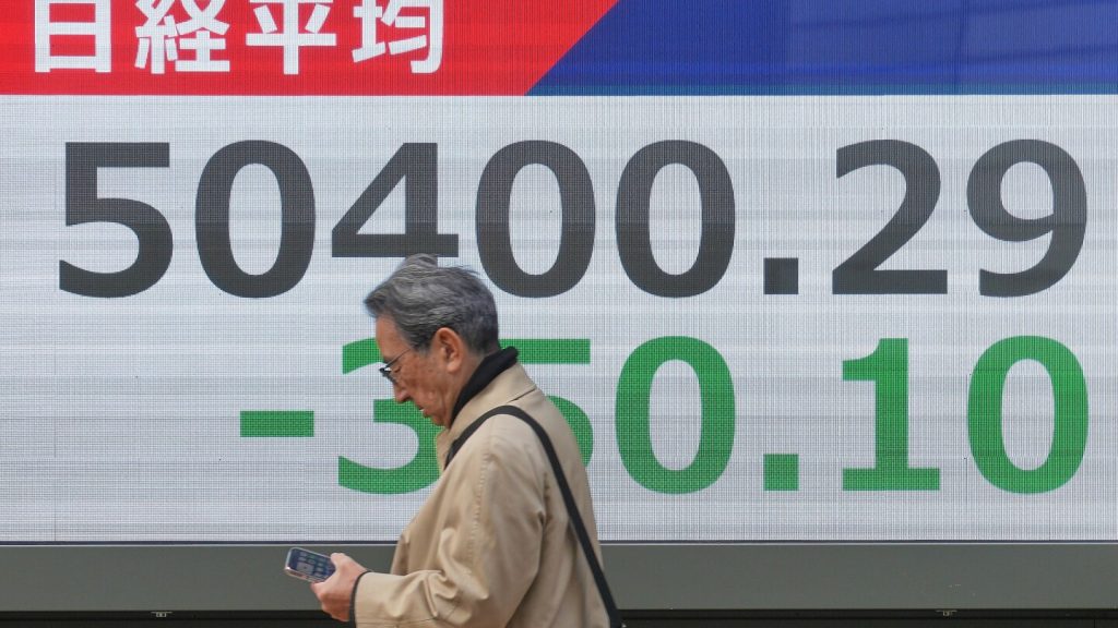Asian shares are mostly lower in quiet holiday trading as China stages war drills near Taiwan