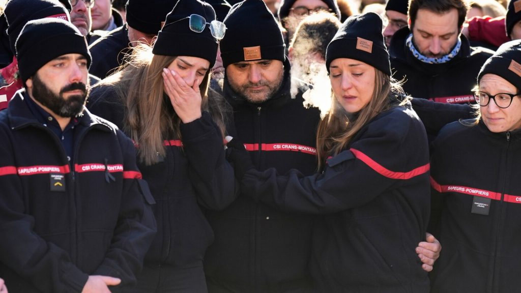 Hundreds march in silence to honor victims of Swiss bar fire that left 40 dead