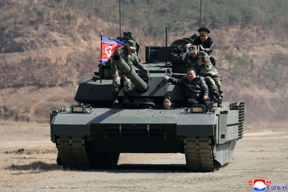 Teen daughter of North Korean leader Kim drives a tank while observing drill with her father